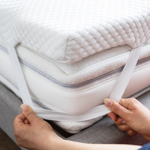 Mattress Topper Being Laid On Top Of The Bed