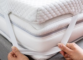 Mattress Topper Being Laid On Top Of The Bed